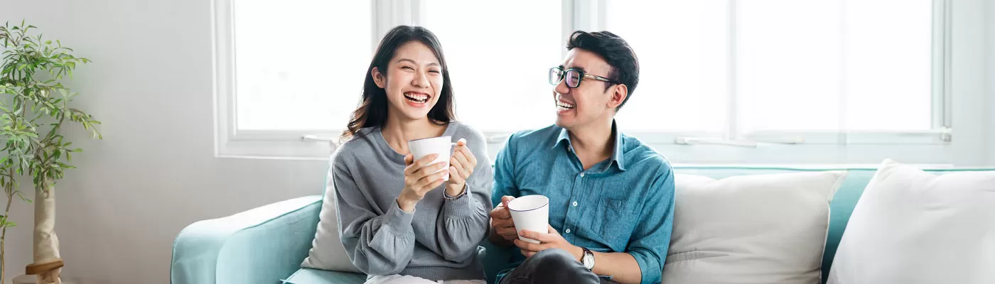 Couple on sofa with coffee